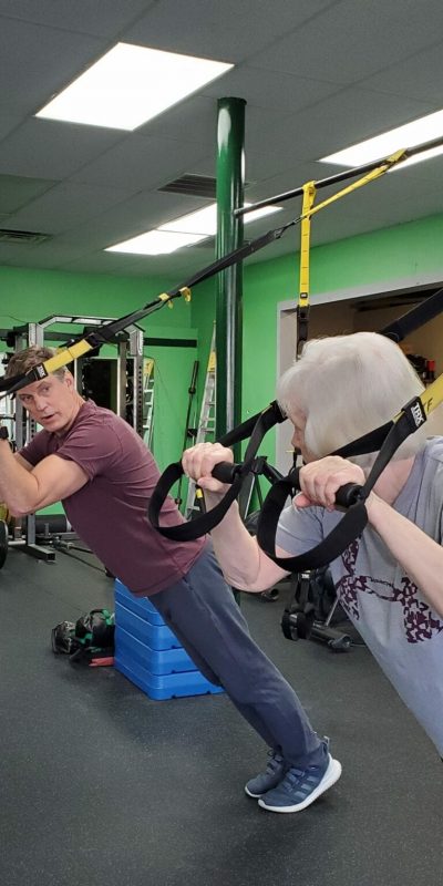 older woman and and John on TRX